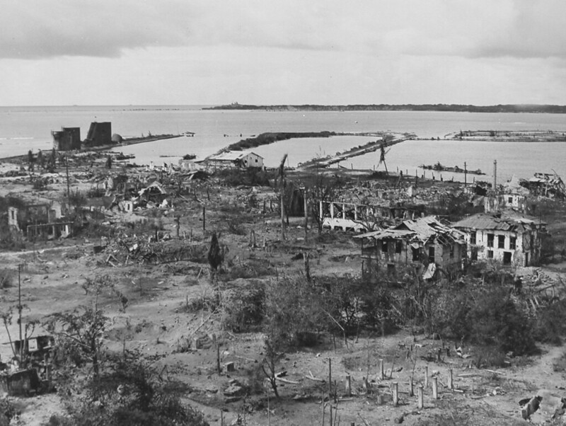 The wrecked town of Sumay on Guam Island in the Marianas when marines recapture it. The ruins give indication of the fierce fighting that took place. In the background is Cabras Island. 1944.

National Archives/Micronesian Seminar