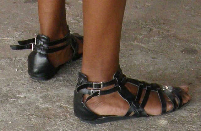 Girl barefoot in leather gladiator sandals