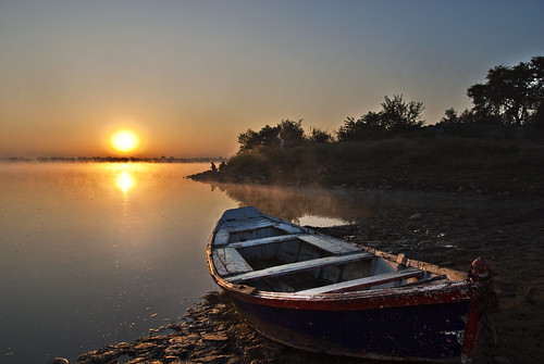 blue pakistan sky orange sun white mist man tree water yellow fog river dark boat fishing mud puddles ligh jhelum