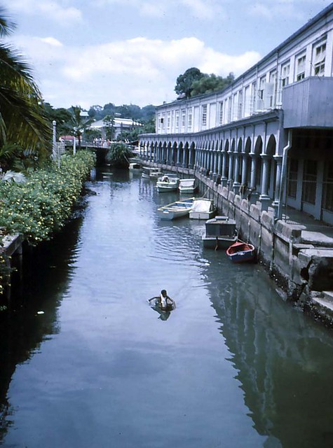 Suva canal, a local boy navigates boat by hand