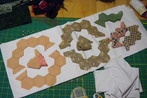 When I unpicked the half-hexes, I tried to preserve as much work as possible by leaving the work in sections. 

The folded pieces I don't have matches for, so I'll need to completely unpick the rest of the seams and use them for interiors.

More info: domesticat.net/2010/06/hexatrix