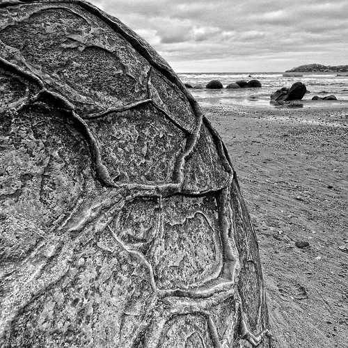 newzealand bw texture beach water rock coast blackwhite sand nikon large overcast nz round southisland otago geology nikkor moerakiboulders moeraki nzl d300 concretions nz101moerakiboulders 1024mmf3545g