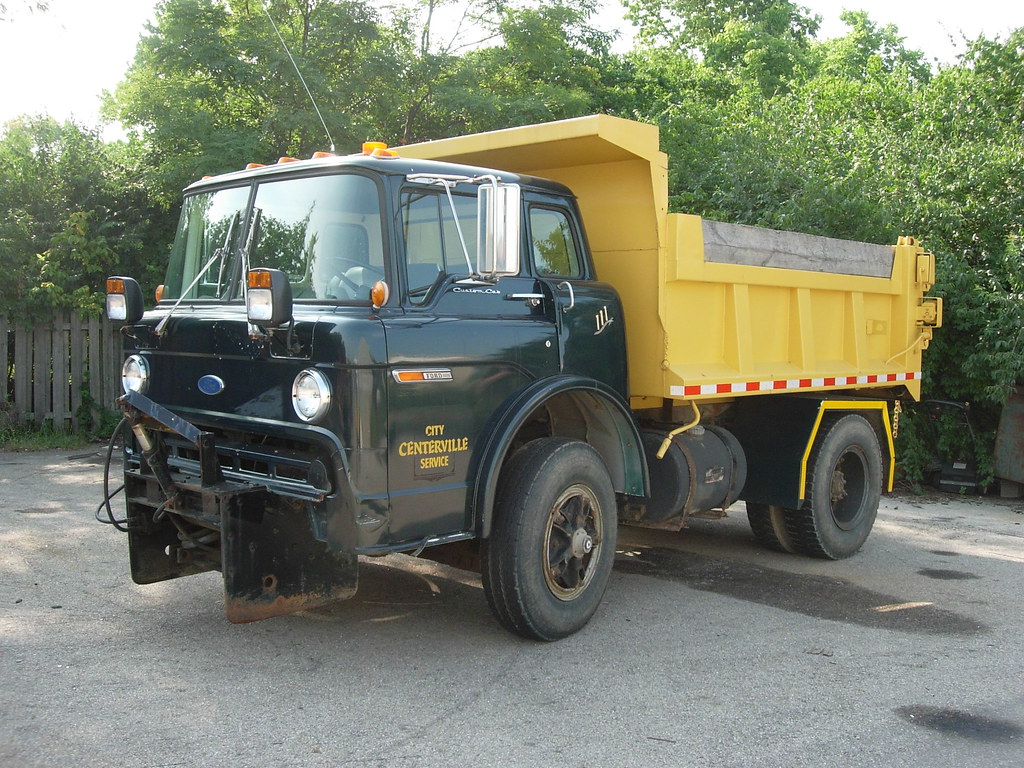 A 1980's vintage Ford C-Series cabover dump truck with Fisher snow plo...