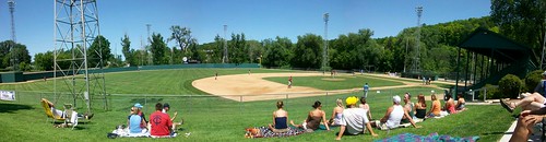 park trees light summer sun game cold classic beautiful field grass minnesota spring day sitting view angle baseball hill crowd watching towers wide rick sunny panoramic jordan dirt tournament backdrop towels indians poles fans blankets amateur tanning infield cheering coors stands springers outfield lawnchairs shakopee granstand burtzel minimet