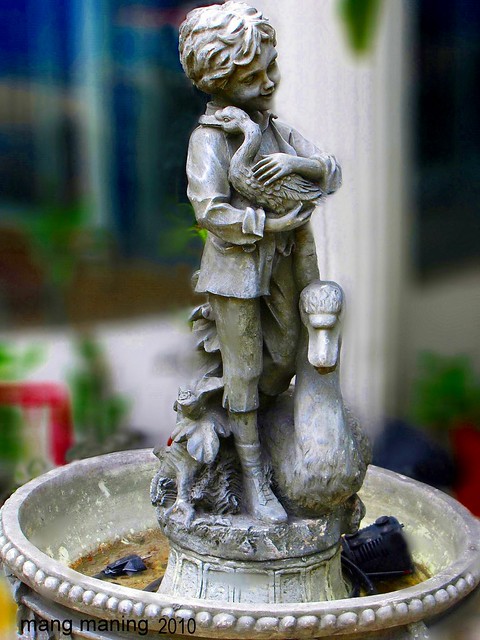 Boy Holding Duck Fountain
