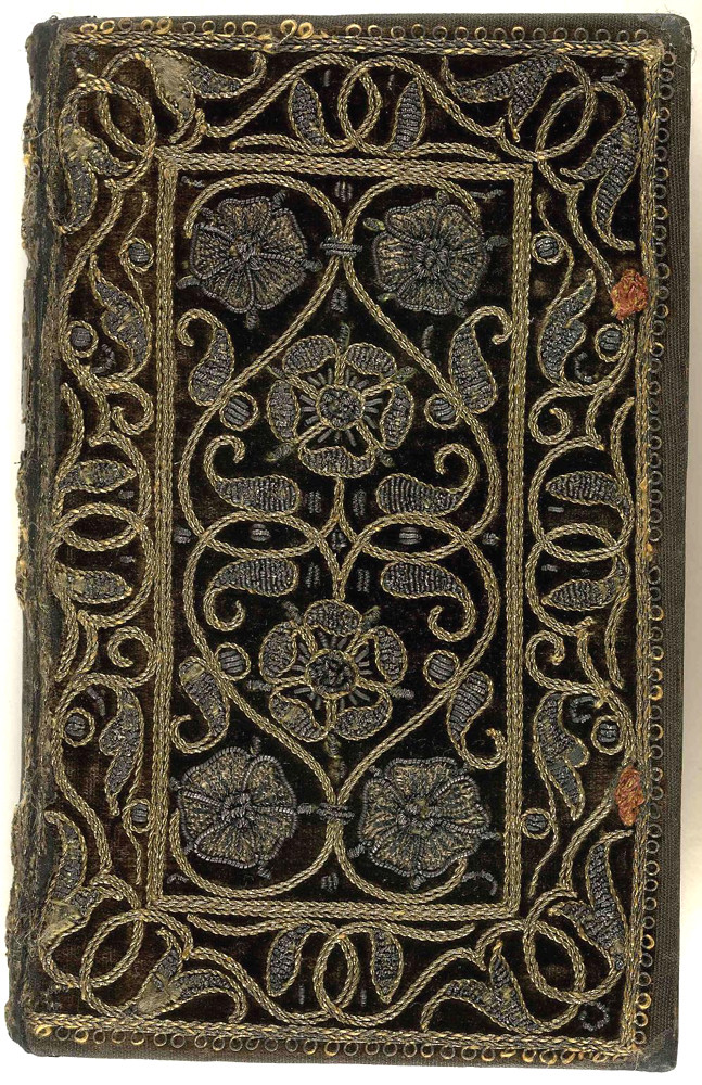 16th century embroidered velvet book with scroll and floral pattern.