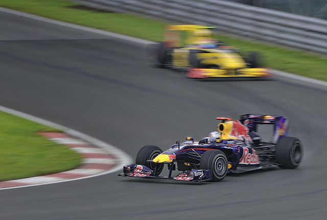 Sebastian Vettel in his Red Bull gets chased down by a Renault