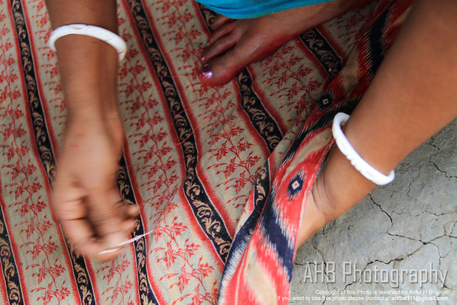 A women is busy on stitching Katha for personal use [Shimulia, Dhamrai (Dhaka) - Bangladesh]