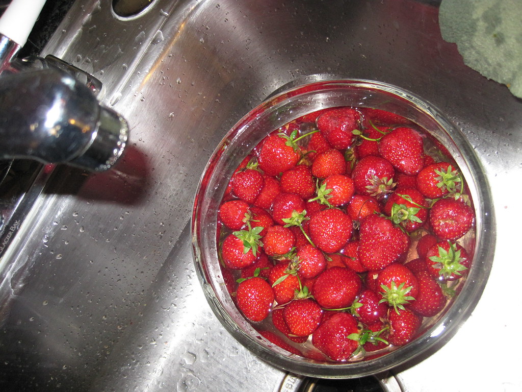 fraises dans un saladier d'eau pour les laver
