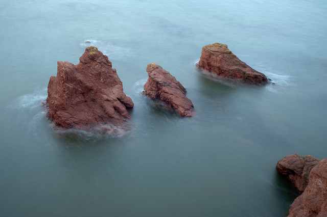Three rocks make their escape from the shoreline