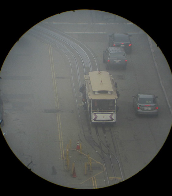 A view of a cable car in the fog on Powell St.,from the refractor in our room.