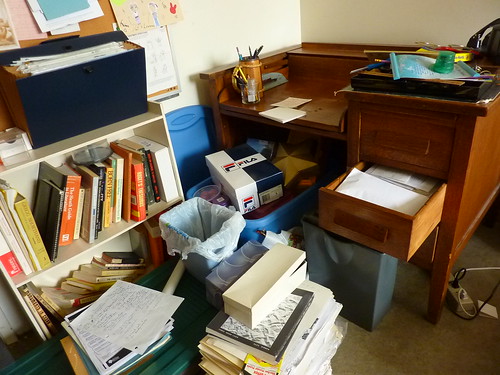 messy papers books secretary desk