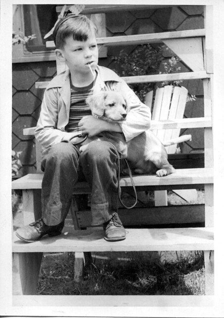 A Boy & His Dog on the Wooden Fire Escape. (Symbolic).