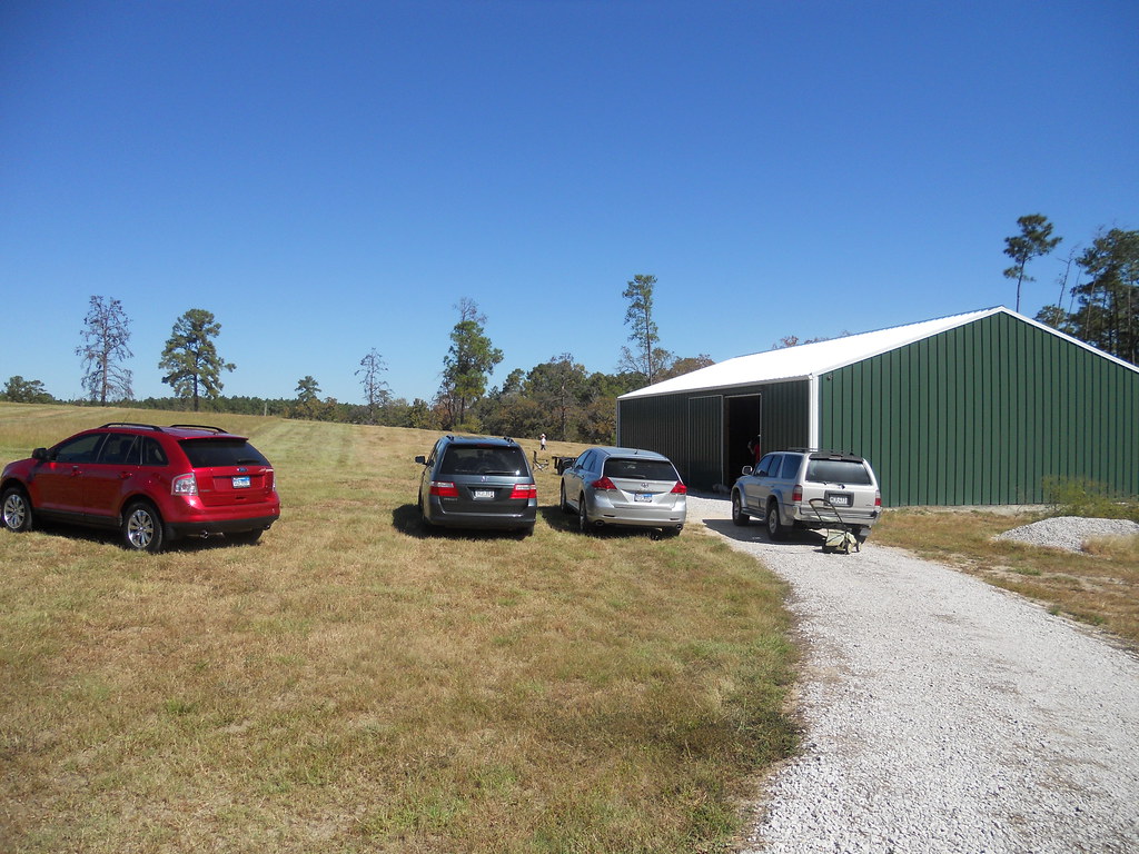 Real-life barndominium with cars parked in front, capturing the essence of rural living.