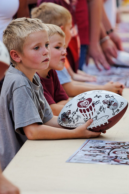 Boys Waiting to have the University of Montana Football Team Autograph Their Ball