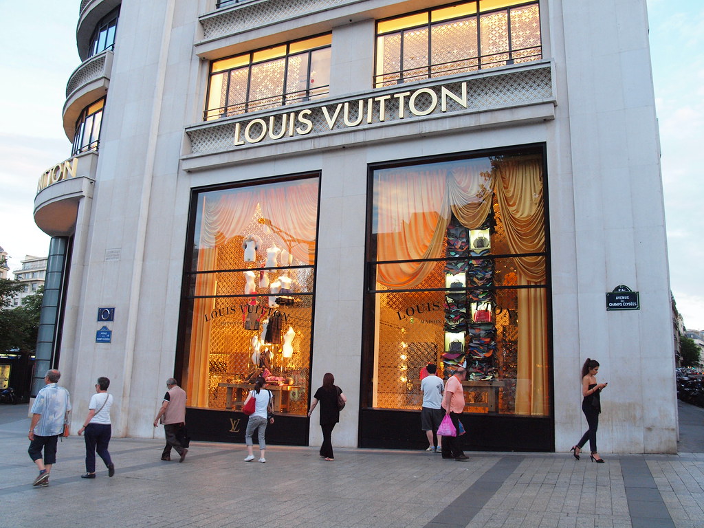 Group of tourist women in front of Louis Vuitton store on Parizska