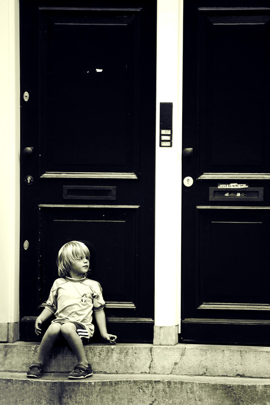 Boy sitting on doorstep