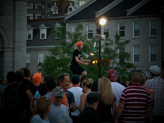 Juggler, juggling three torches on a unicycle