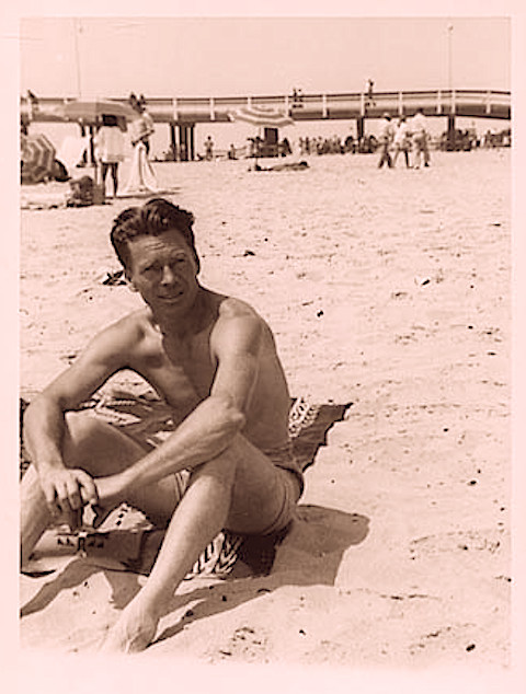 1950s Shirtless Man On Beach In Swim Trunks Shorts Blanket