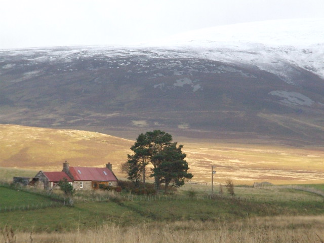 Snow-capped hills above a cottage