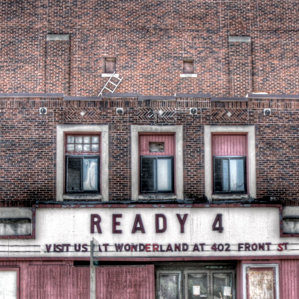 Brick storefront with a sign above the windows
