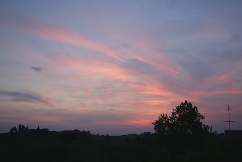 watch the sky by -Vik, pink blue houses sunset sun tree purple hills setting
