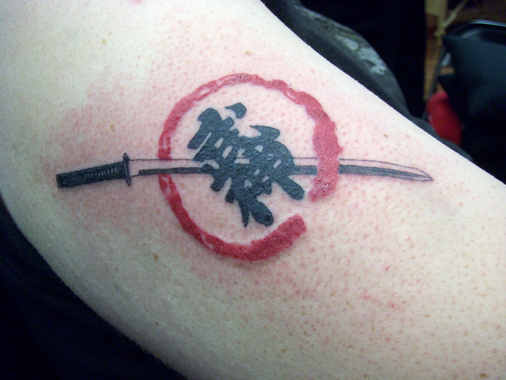 Ninja tattoo on upper arm.