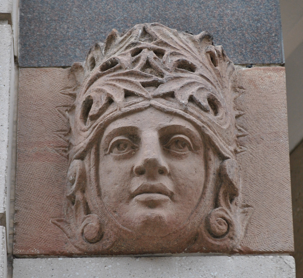 Carved figure at Washington Center entrance (left side)