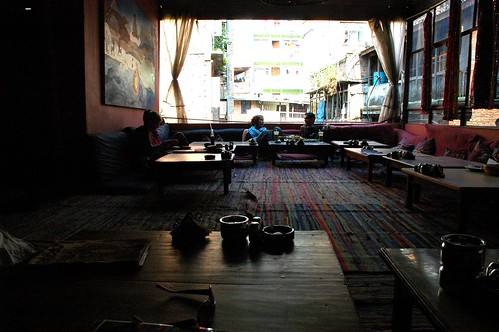 Friends chatting, Cool funky OR2K Restaurant, low tables, futons, wide open huge windows, Kathmandu, Nepal