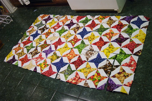 Progress! This will be a king-sized quilt when it's completed. It's right at the halfway point now, and my source fabrics are holding up. As long as I cut carefully, I should have enough to finish the quilt without buying more.

For details on who this quilt is for, and why the quilt is named 'Eat This Quilt,' see domesticat.net/quilts/eat-quilt

Current size: 25 squares by 14 squares, or 87.5' x 49'. Intended finished size: 100' square.