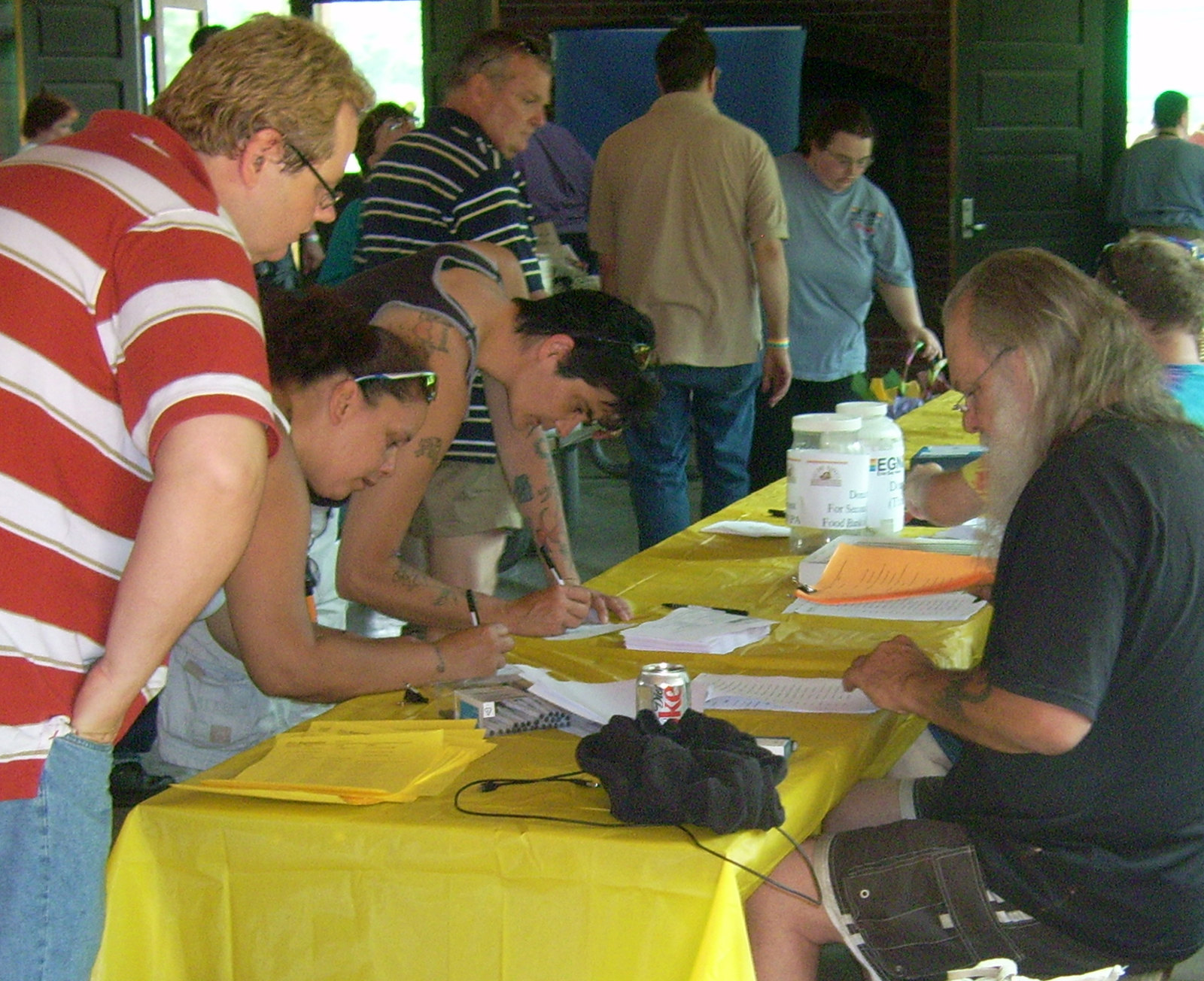Dok checking people in at the registration table. Photo by James von Loewe