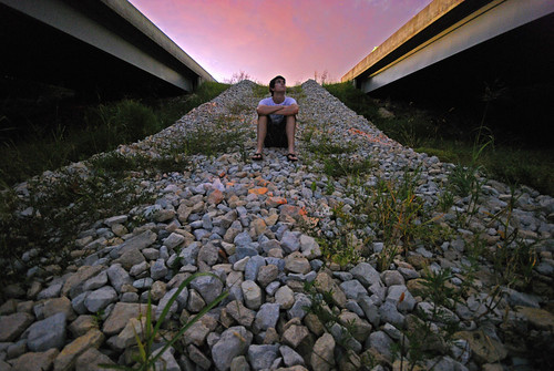 bridge sunset sky person highway rocks sitting angle dusk watching wide overpass
