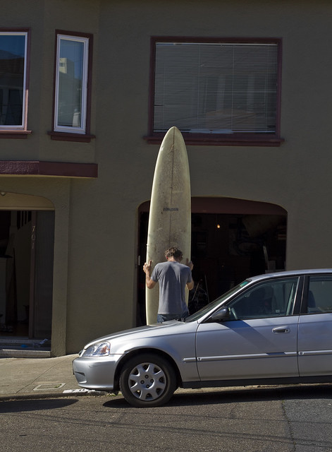 Man with long surfboard; The Richmond, San Francisco (2011)