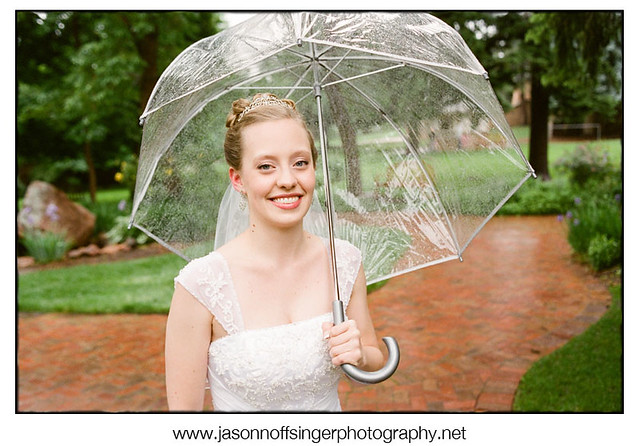 The Bride stands for a portrait in the rain