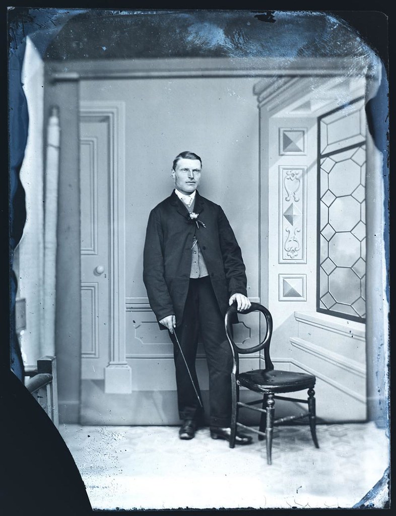 Early wet plate collodion portrait of a Victorian gentleman showing details of the surrounding studio. collodion, glass, nega