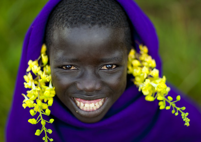 Surma smiling kid with flowers - Turgit Ethiopia