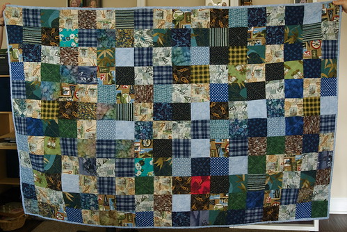 Misty and Kat were kind enough to hold up the quilt, so I could finally have a straightforward photo of the finished quilt. I kept this one; the fabrics have personal meaning to me. It's roughly twin-sized, and is used on the back of our love seat. Blog entry: domesticat.net/quilts/kissing-thief