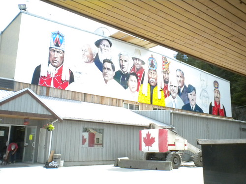 Wide building view with a completed portrait mural