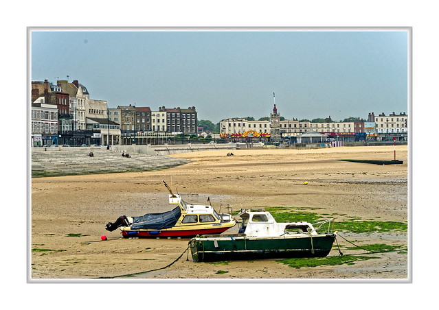 Margate harbour and sea front at low tide.