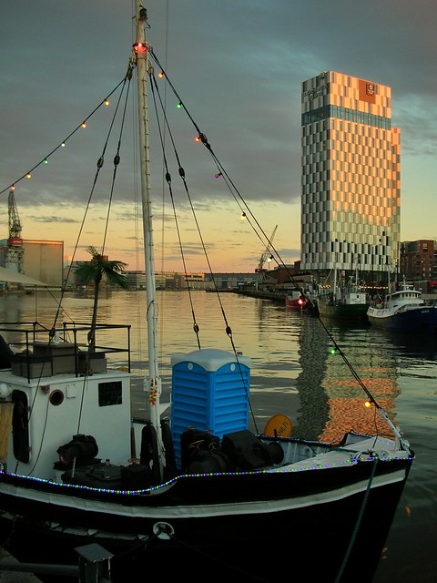 The ship and the high rise at dusk.