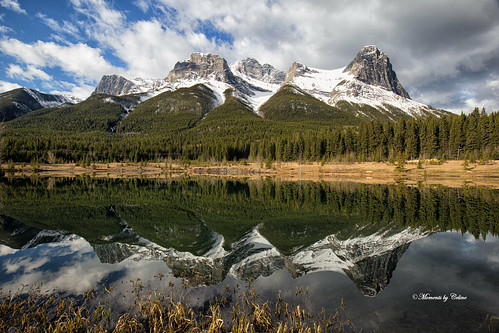 reflections water mountains mountainpeak snowcapped snow trees scenery sky scenic nature nationalpark canmore alberta canada clouds calm colours landscape mountain lake quarrylake bluesky