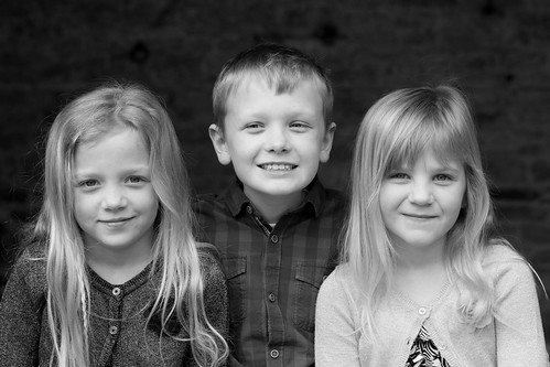 Beautiful young siblings pictured in soft black and white.