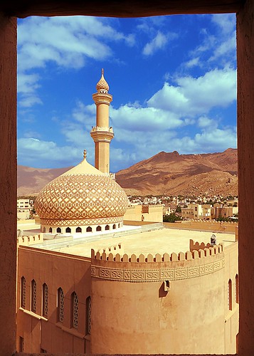 mosque fort nizwa oman frame mountain clouds crayons minaret sky yellow brown city landscape