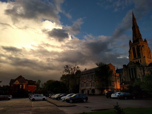 drama by ..Lana.., sunset reflecting in the storm clouds over a parking lotsunset sunlight clouds stormclouds parkinglo