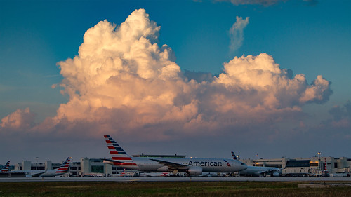 clouds evening eveninglight 777 aa aal american americanairlines florida aviation aircraft airplane airliner airport airside apron plane heavy widebody longhaul hub terminal miami mia kmia boeing 777200 772 b777 b772 cloudscape civilaviation flap flav dusk sunset jet jetliner tripleseven ramp taxiway twin