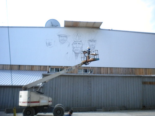 Lift below portrait outlines on a building