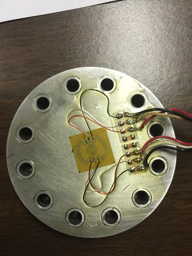 September 21, 2015 - 5:00pm - Shown is a Micro-Measurements circular diaphragm gage installed on the diaphragm of a pressure transducer.  Diaphragm gages are special, full-bridge strain gages, designed for constructing pressure transducers.  Also note the use of colored, 134-AWN wire which is useful in keeping track of the power and signal corners of the Wheatstone bridge while wiring the installation.