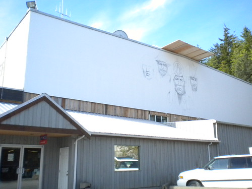Building wall with early mural outlines above the roof