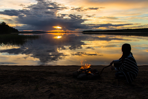 woman and a campfire | by VisitLakeland