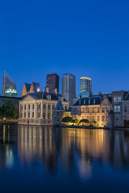 Binnenhof Palace of Parliament inThe Hague in The Netherlands Shot During Blue Hour Time. Against Modern Skyscrapers on Background.